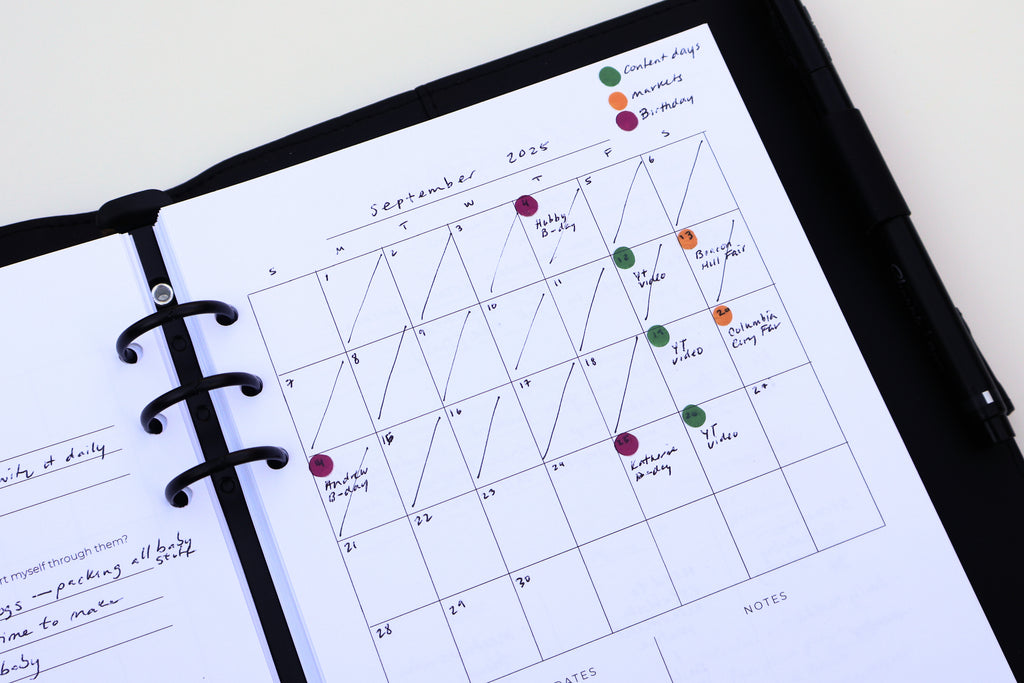 Calendar page in a planner with color-coded notes on a white background
