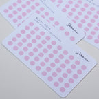 Pink dot stickers on white cards with Serene branding on a light gray background