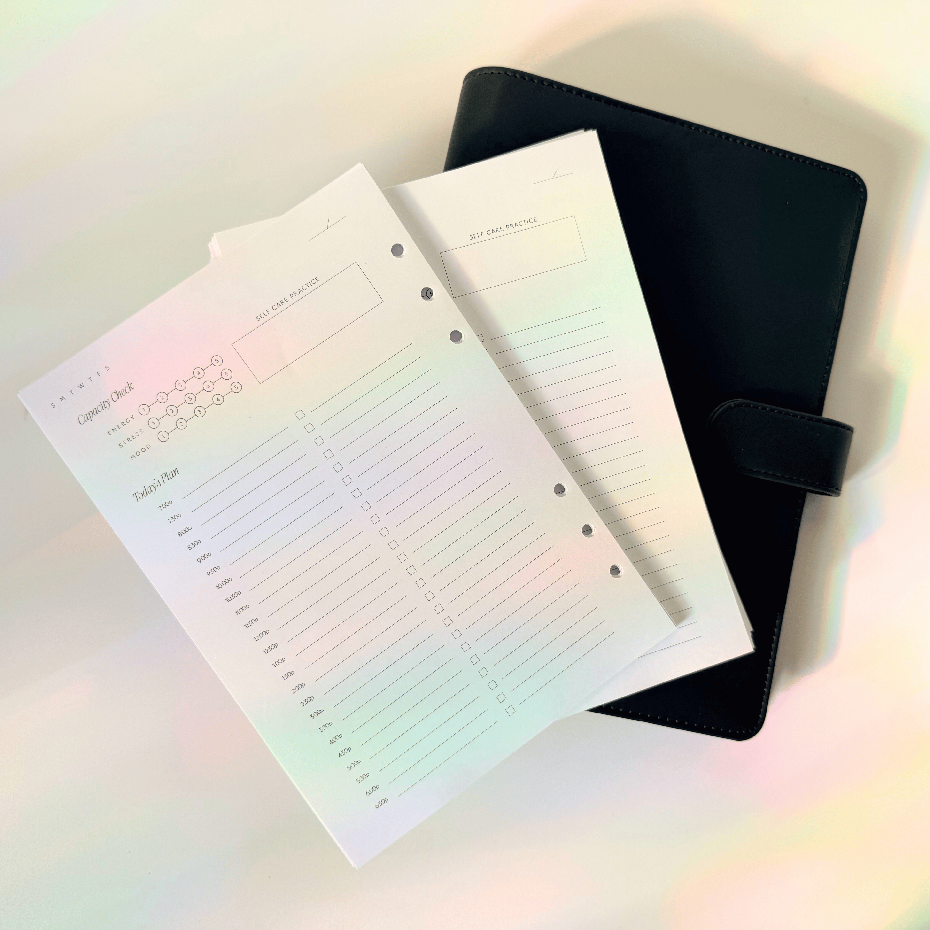 Two notebooks with lined pages and a black cover on a light background