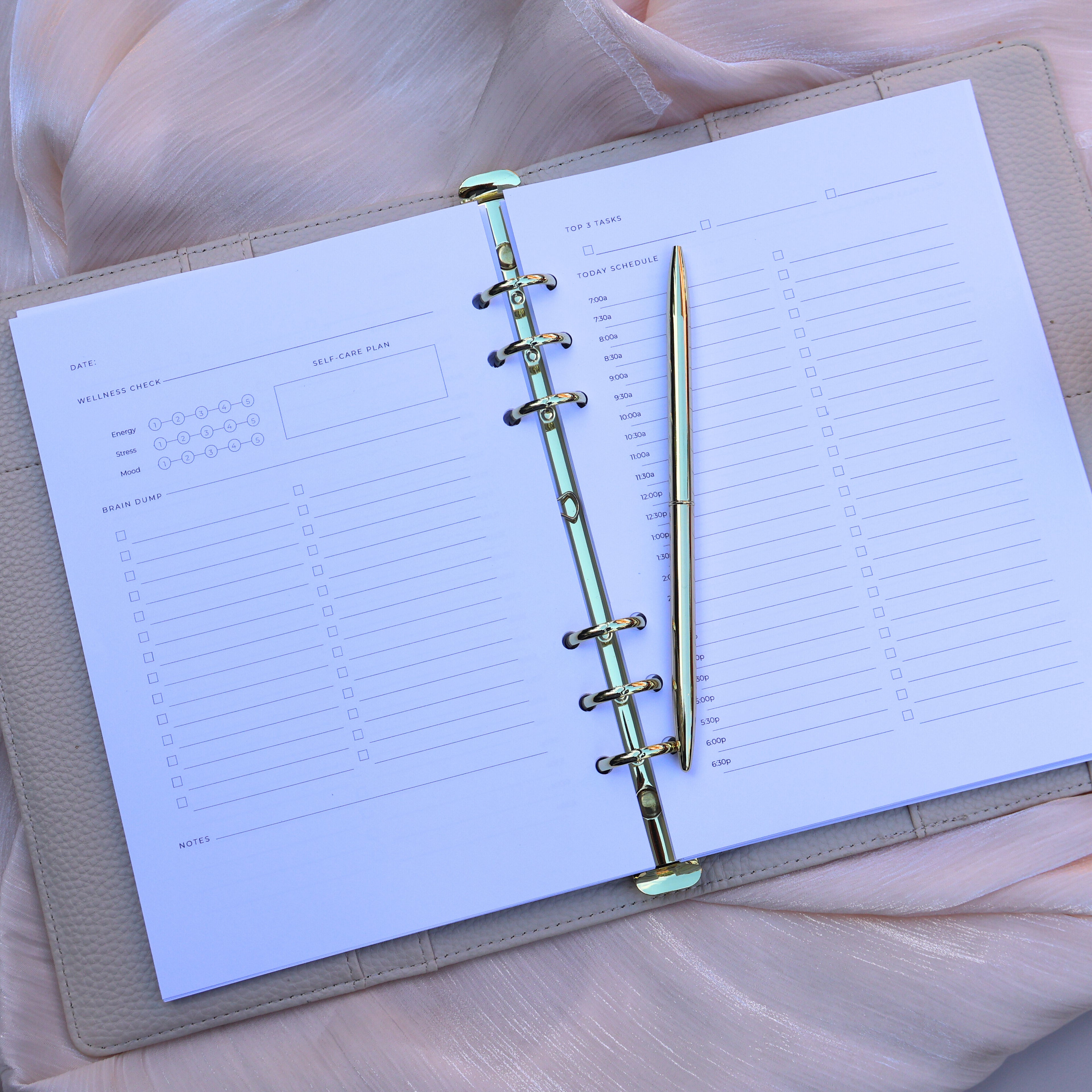 Open planner with a pen on a soft fabric background