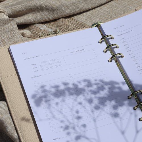 Open 6 ring planner with daily task checklist and the wellness check. 