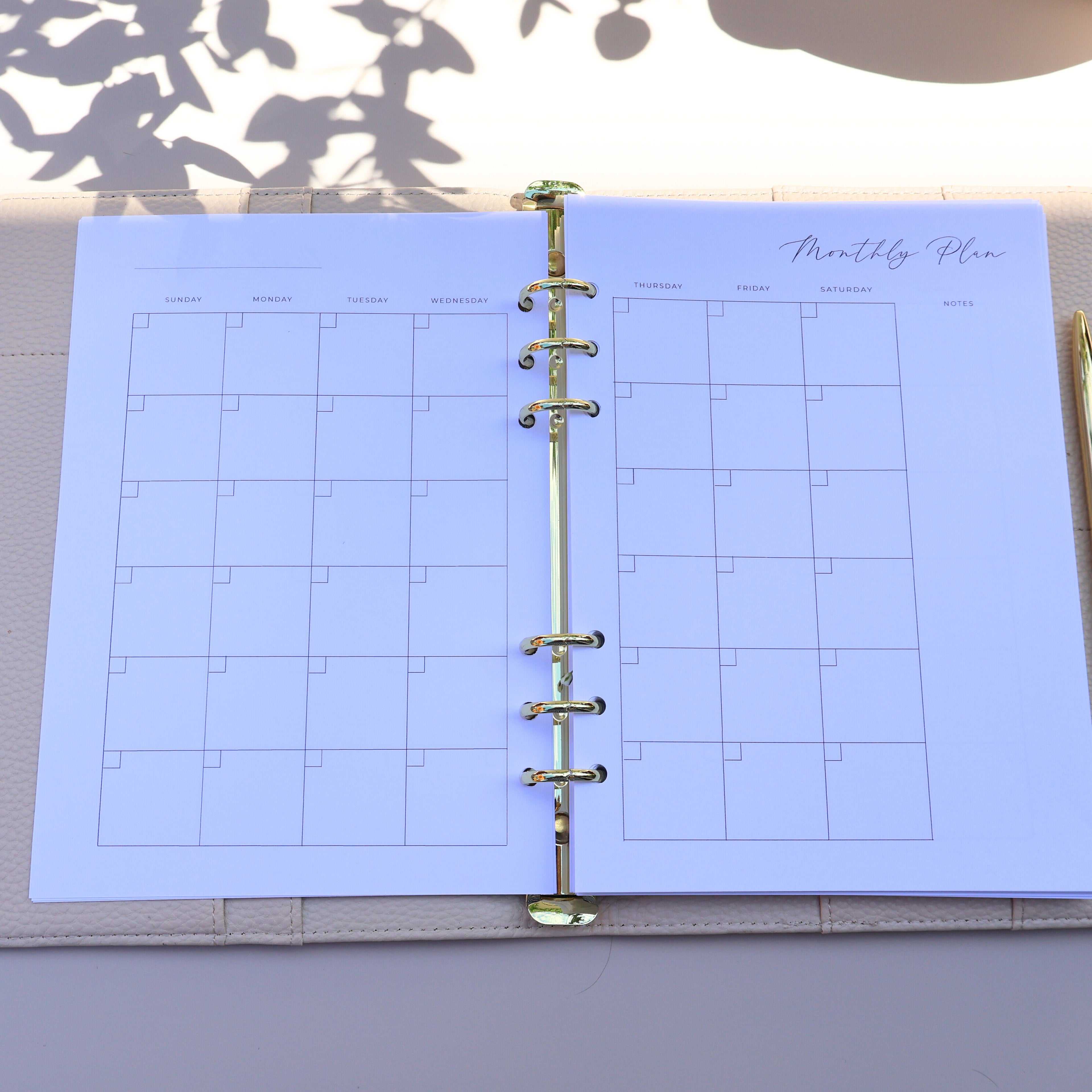 Open planner with monthly schedule on a light surface