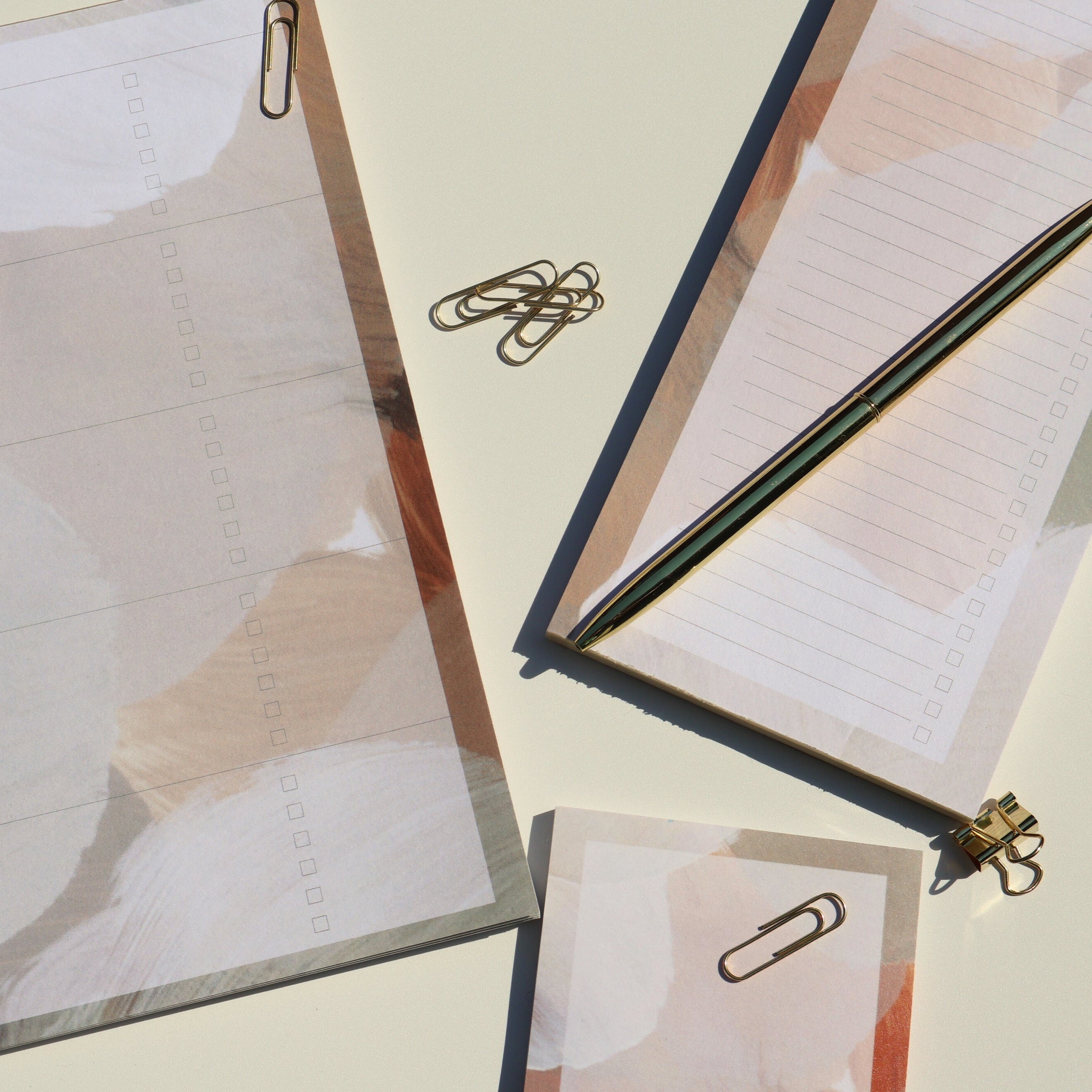Notebook with a pen and paper clips on a light background