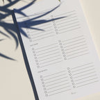 Checklist paper with shadows of plants on a light background