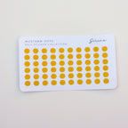 Sheet of mustard yellow polka dot stickers on a white card with 'Serene Paper Co' branding.
