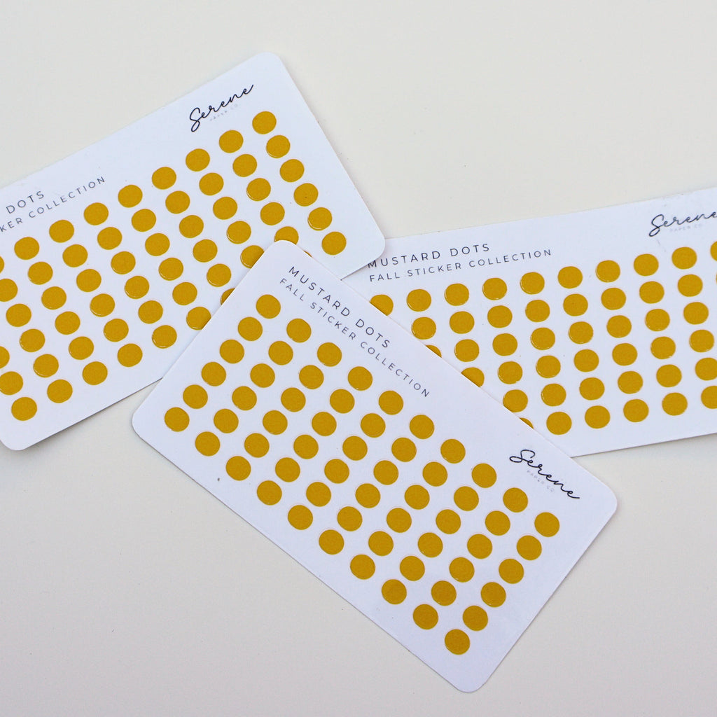 Four sheets of yellow dot stickers on a light gray background