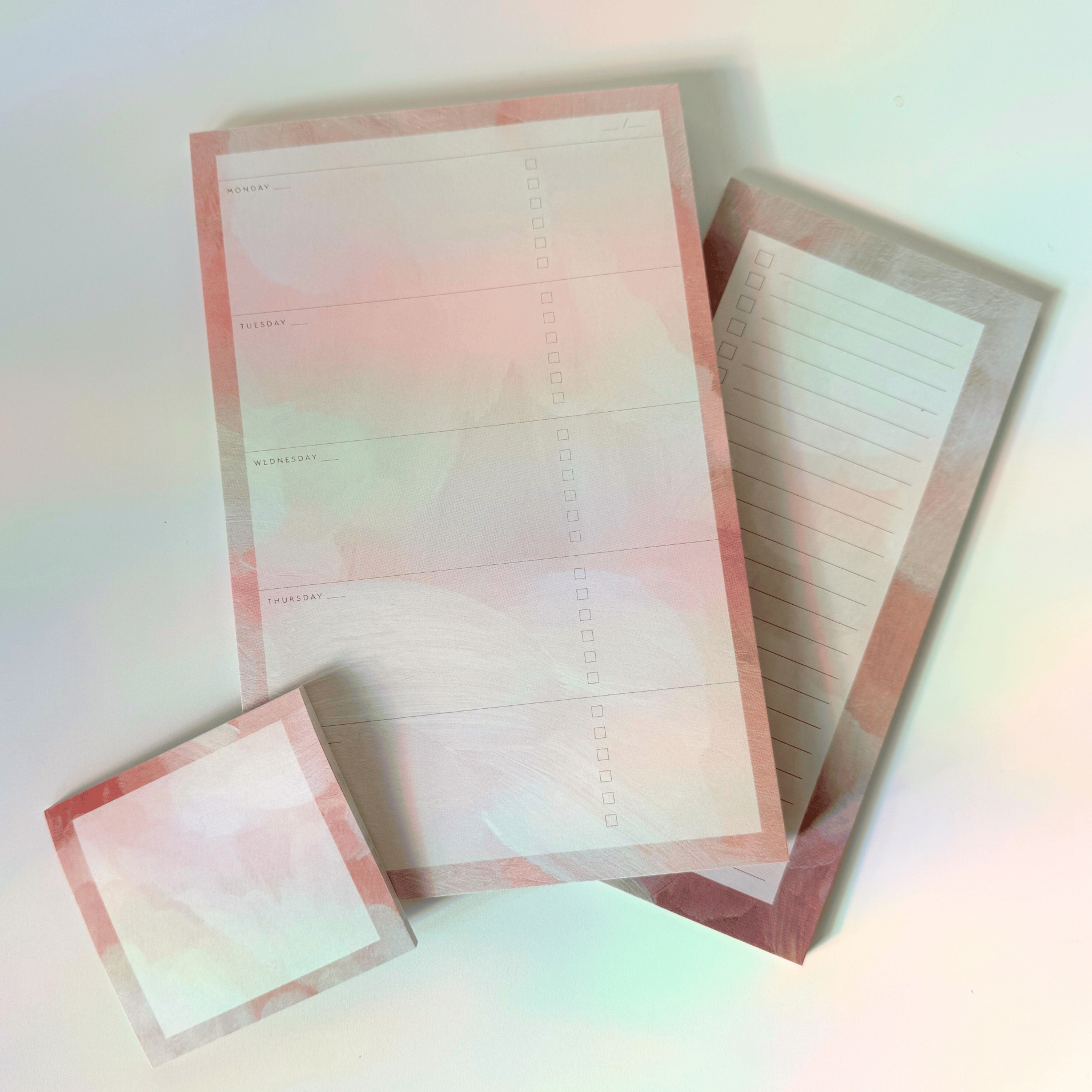 Set of lined paper sheets with a pink border on a gradient background