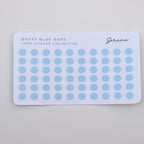 Card with dusty blue dot stickers on a light gray background