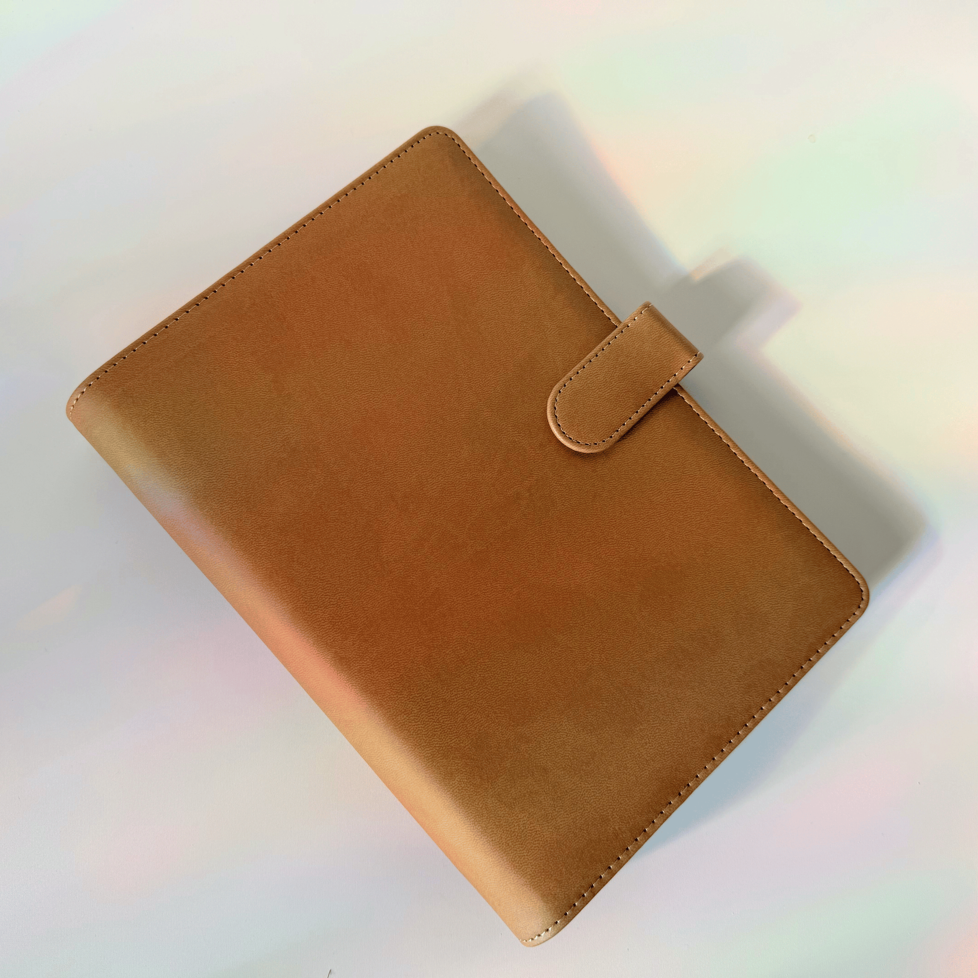 Brown leather notebook cover on a light background