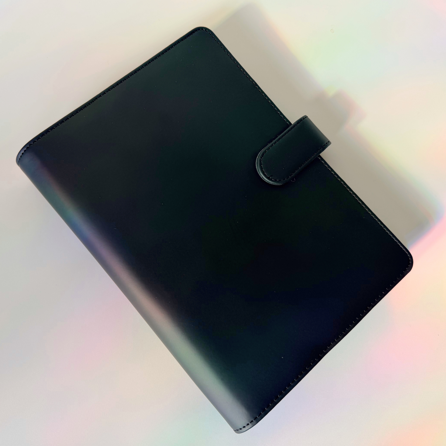 Black planner cover on a gradient background