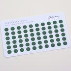 Card with green dot stickers labeled 'Evergreen Dots' on a beige background