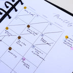 Close-up of a planner with monthly layout and notes.