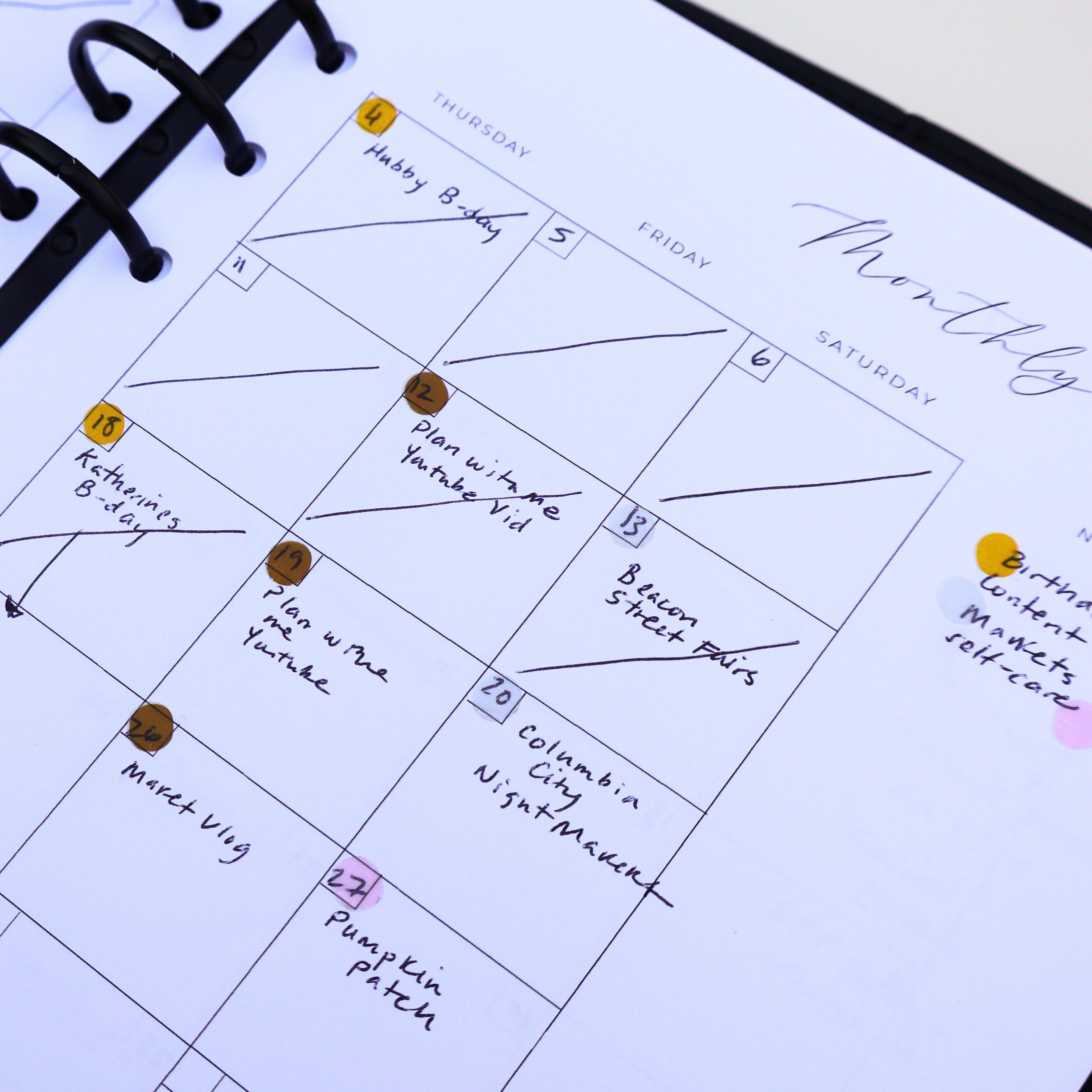 Close-up of a planner with monthly layout and notes.