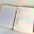 Open planner with a rainbow gradient effect on a light background