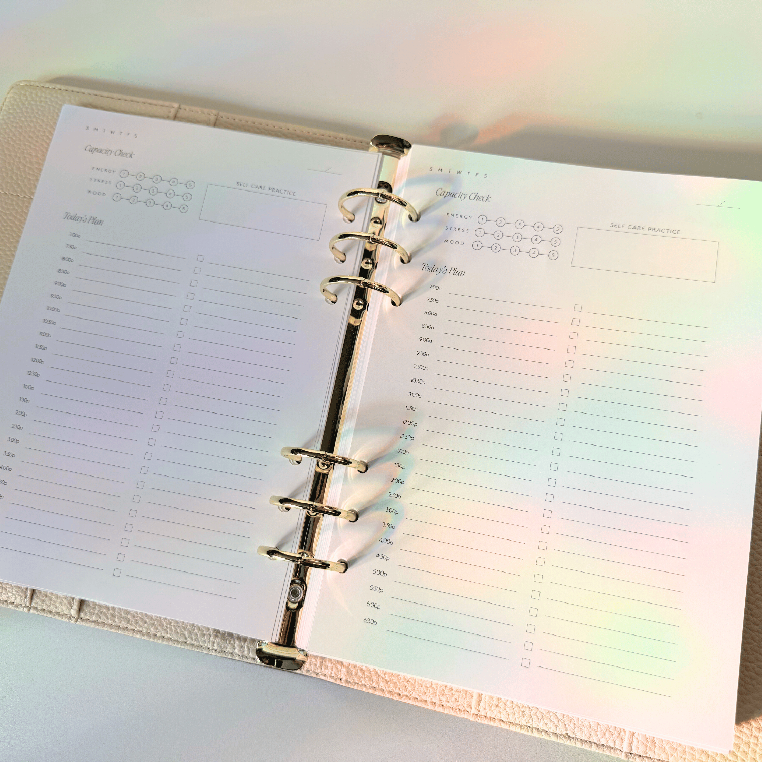Open planner with a rainbow gradient effect on a light background
