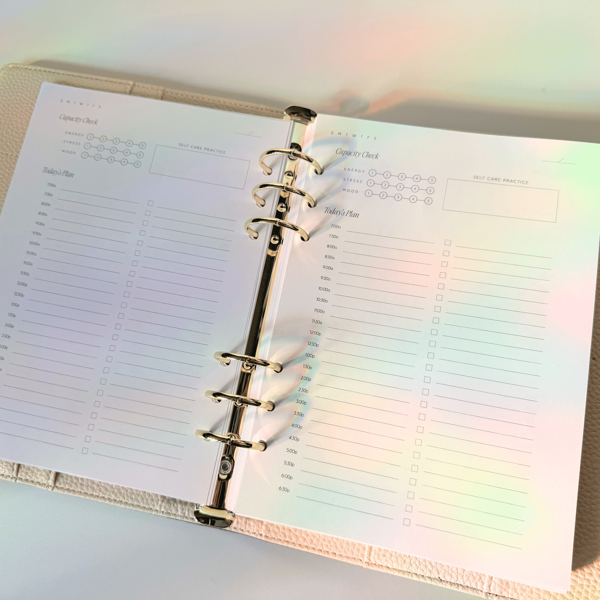Open planner with a rainbow gradient effect on a light background